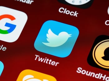 Twitter app icon on a smartphone screen.