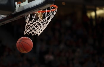 A basketball going through a basketball hoop.