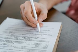 A person signing an agreement with a PR firm.