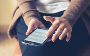 A person holding a smartphone.