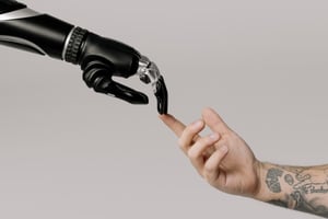 A robot hand touching a human hand.