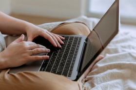 A woman on a laptop.