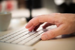 A person typing a byline.