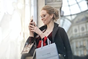 A woman looking at a brand's social media profile.
