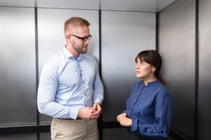 A man and a woman making an elevator pitch for something.