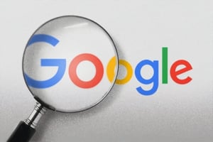 Google logo with a magnification glass over it.