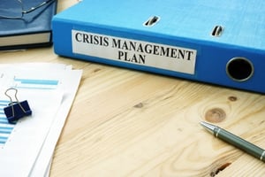 A folder containing a crisis communications plan.
