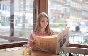 A woman reading earned media.