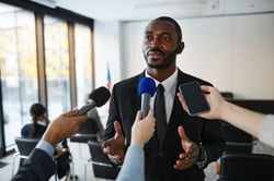 A man speaking with the press.
