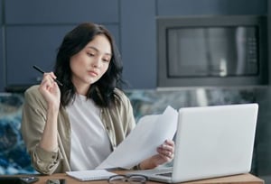 A woman looking at a press release wire service's offerings.