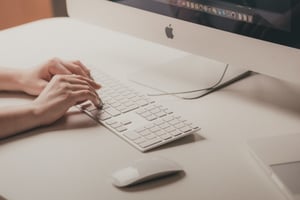 Person typing on a computer.