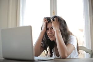 A frustrated woman seeing some SEO mistakes.