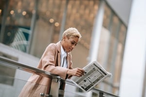 A woman reading a newspaper.