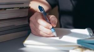 A person writing a zoom in, zoom out narrative.