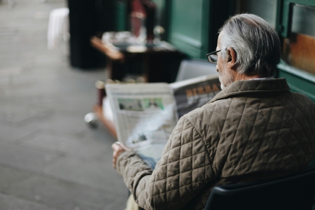 An old man reading a story that appeared via newsjacking.